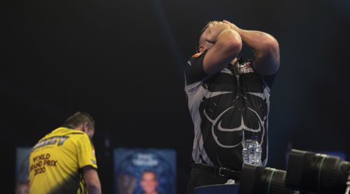 Gerwyn Price hat die Hand vor dem Gesicht